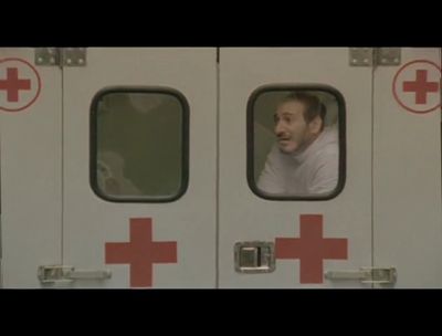 a man looking out the window of an ambulance