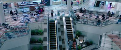 a group of people walking up and down an escalator