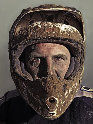 a man wearing a helmet with dirt on it