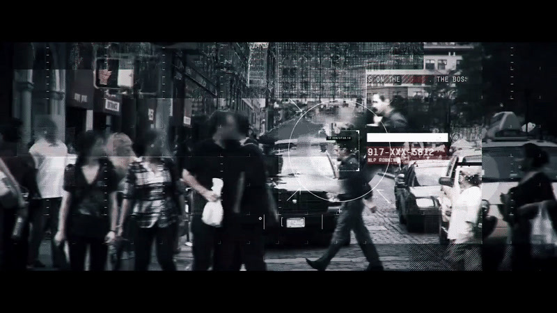 a group of people walking down a street next to tall buildings