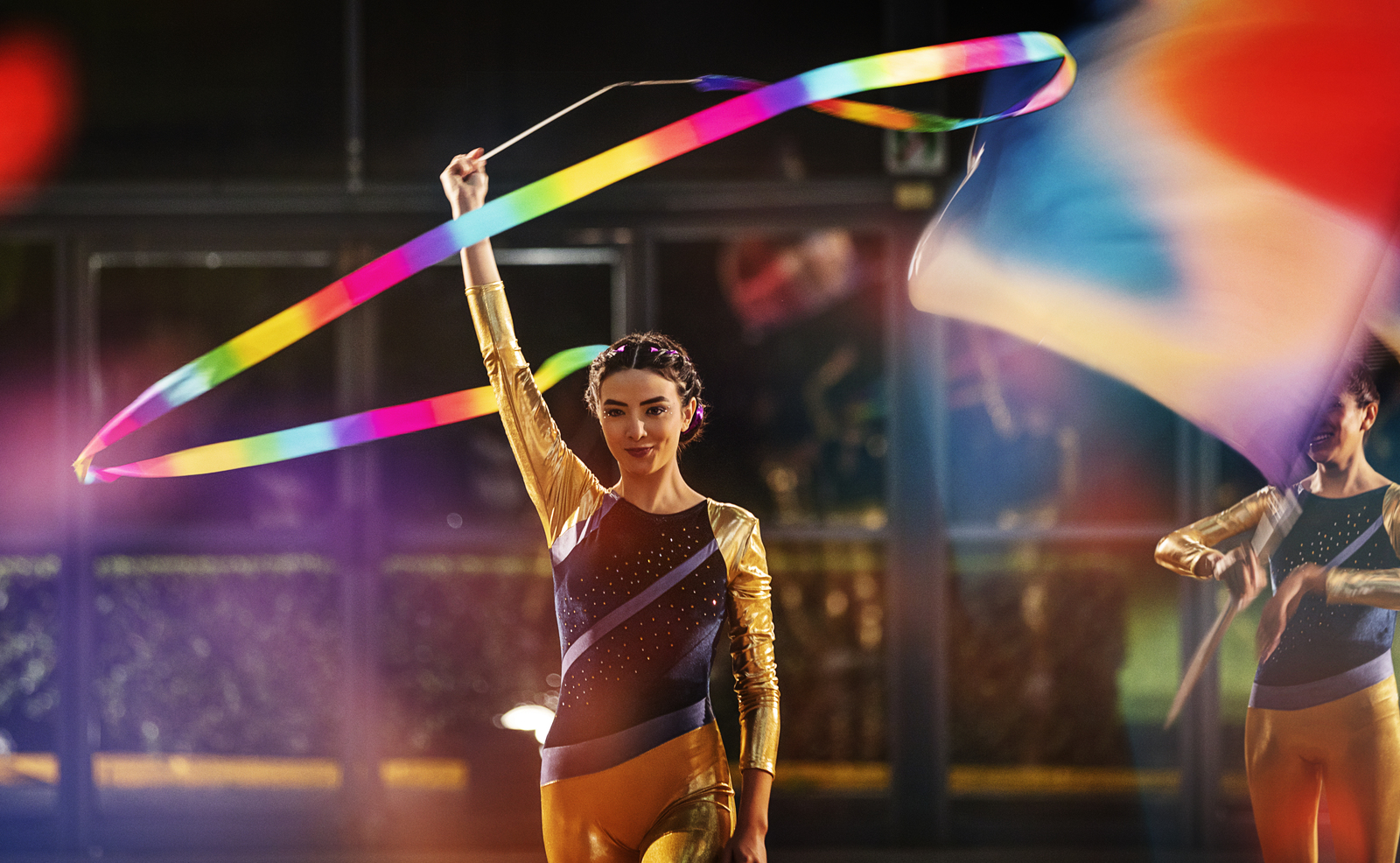 a couple of women holding a rainbow colored kite
