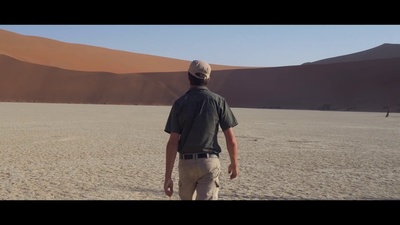 a man standing in the middle of a desert