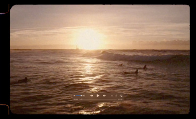 a group of people riding surfboards on top of a wave