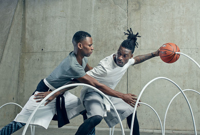 a couple of men playing a game of basketball