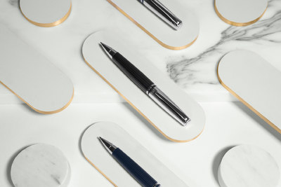 a marble table topped with different types of pens