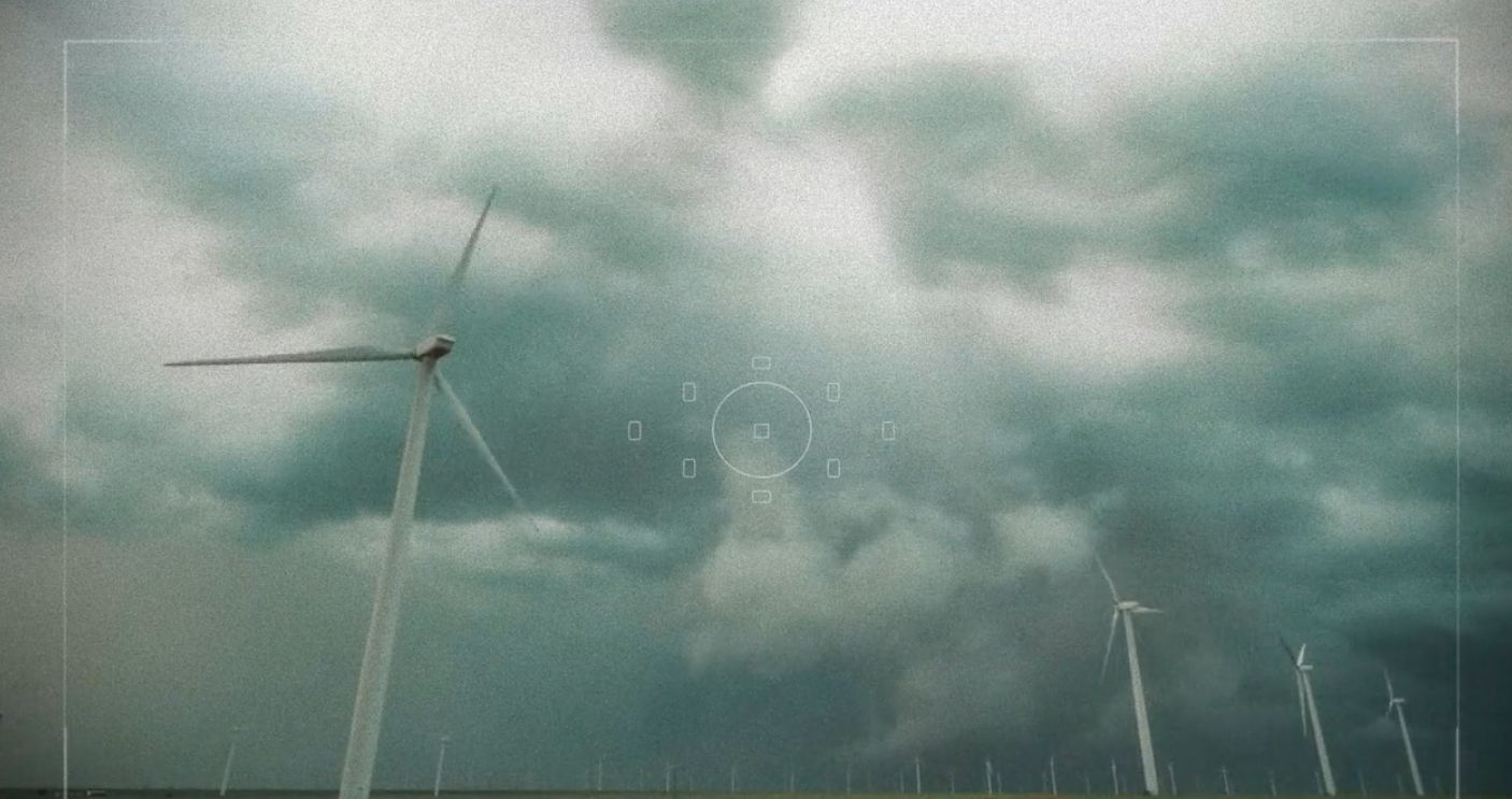 a group of wind turbines on a cloudy day