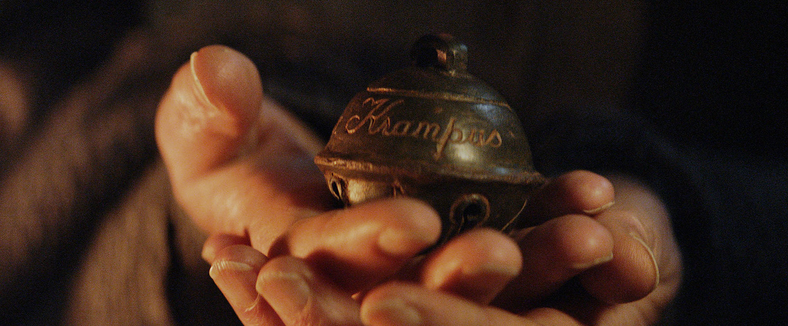 a person holding a small bell in their hands