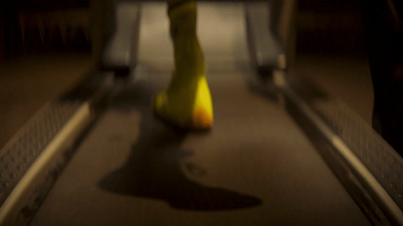 a yellow vase sitting on top of a conveyor belt