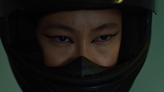 a person wearing a motorcycle helmet looking at the camera