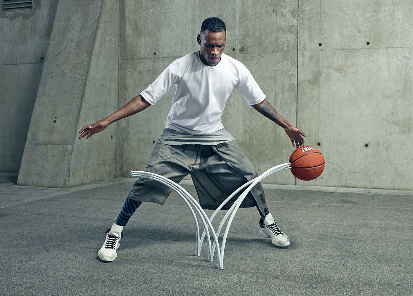 a man holding a basketball while standing next to a hoop