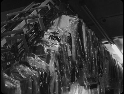 a black and white photo of plastic wrapped clothes