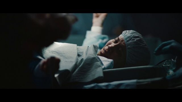 a man laying in a hospital bed with a cast on his head