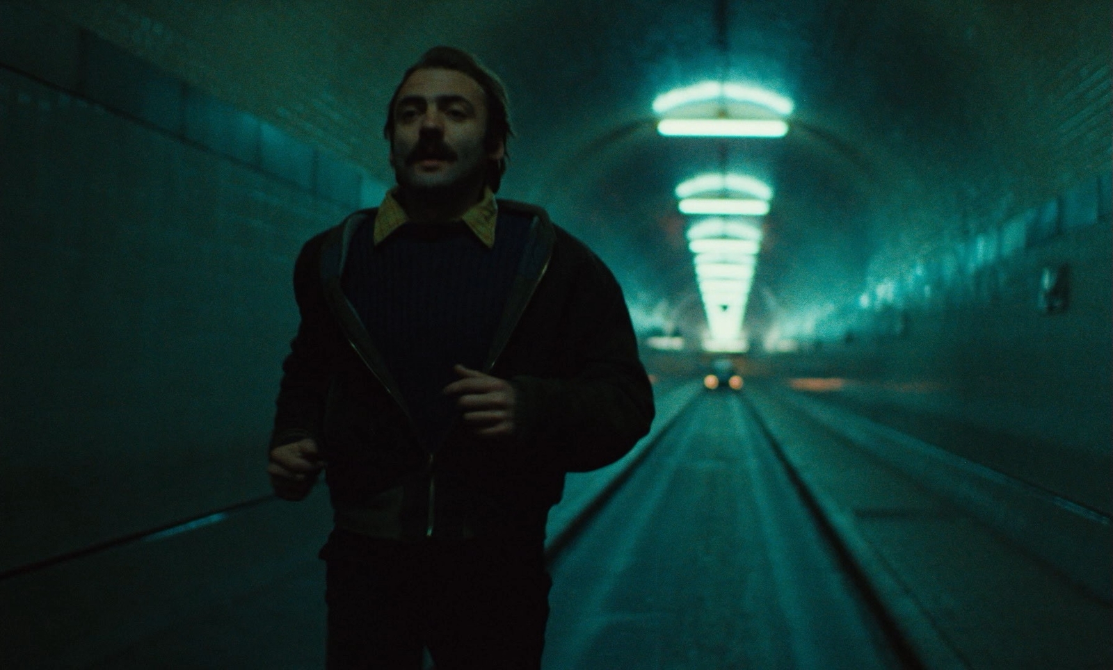 a man standing in a tunnel with a backpack