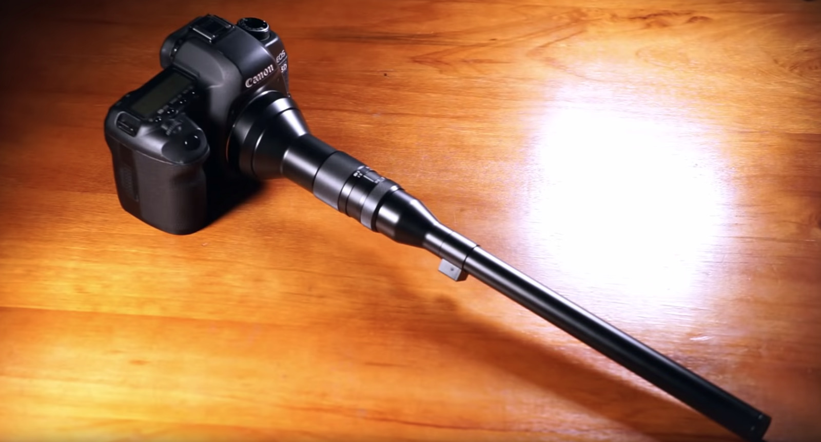 a close up of a camera on a wooden table