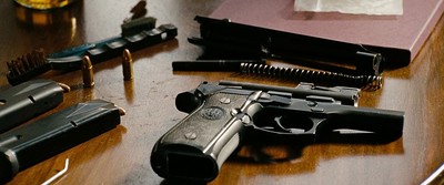 a gun and some other guns on a table