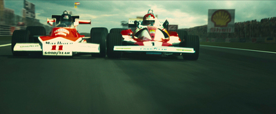 two racing cars driving down a race track