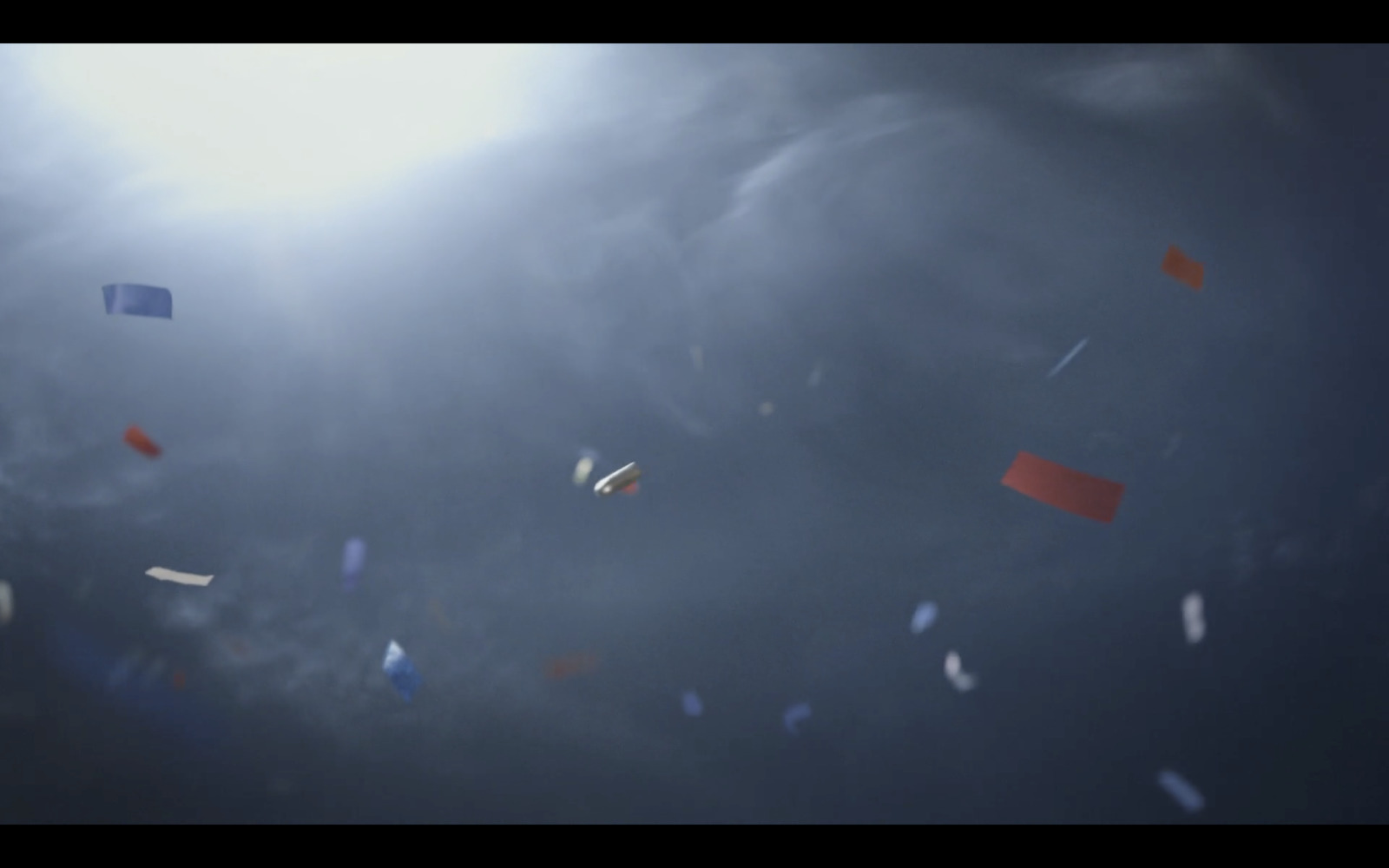 a group of kites flying through a cloudy sky