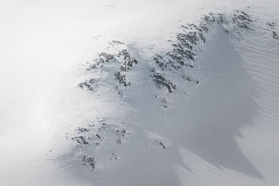 a person riding skis down a snow covered slope