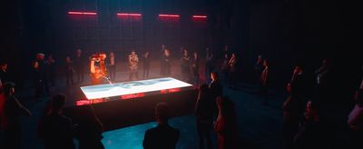 a group of people standing around a table in the dark