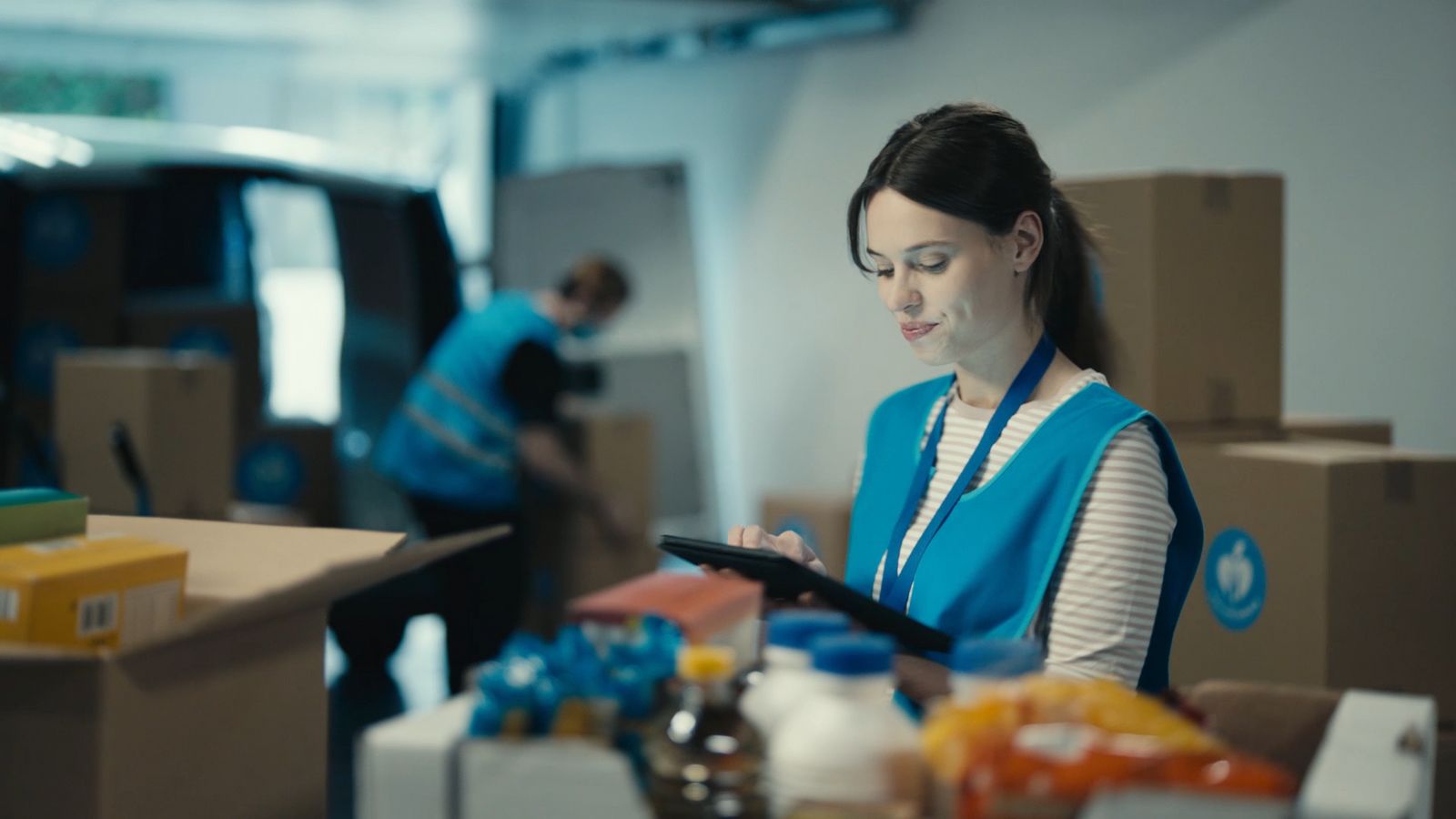 a woman standing in a room holding a tablet