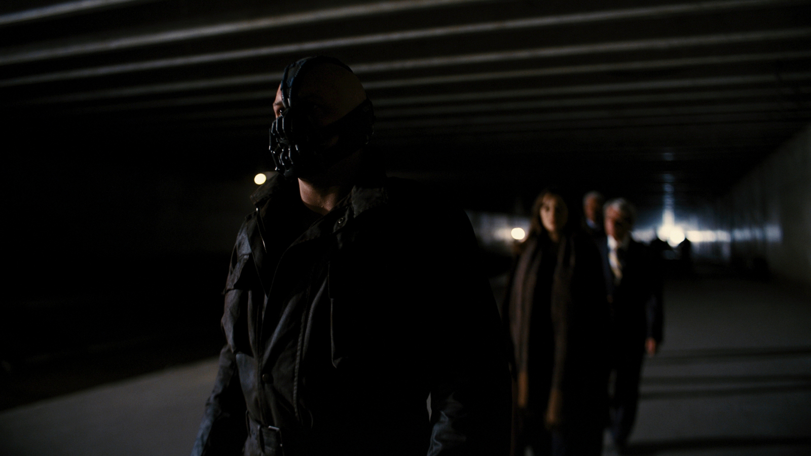 a group of people standing in a dark tunnel