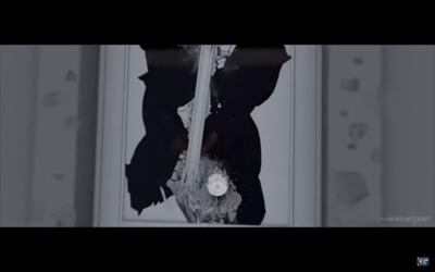 a black and white photo of a broken window