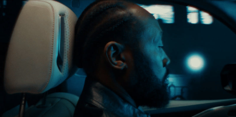 a man with a beard sitting in a car