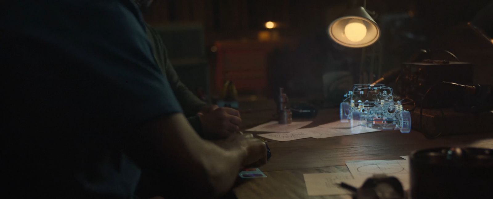 a person writing on a piece of paper in a dark room