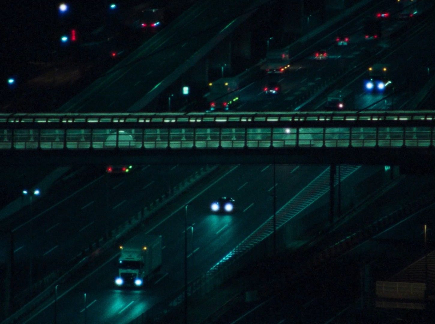 a highway at night with cars driving on it