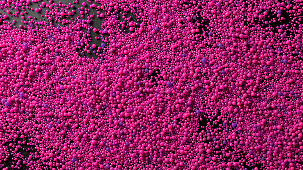 a lot of pink bubbles floating in the air