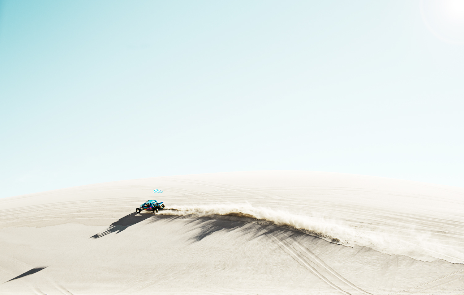 a person riding a dune buggy on a sunny day