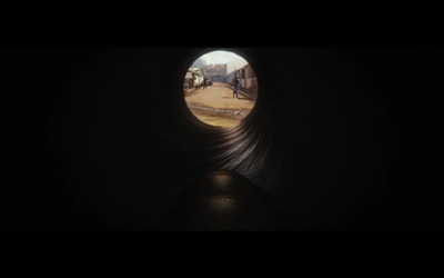 a view of a person walking out of a tunnel