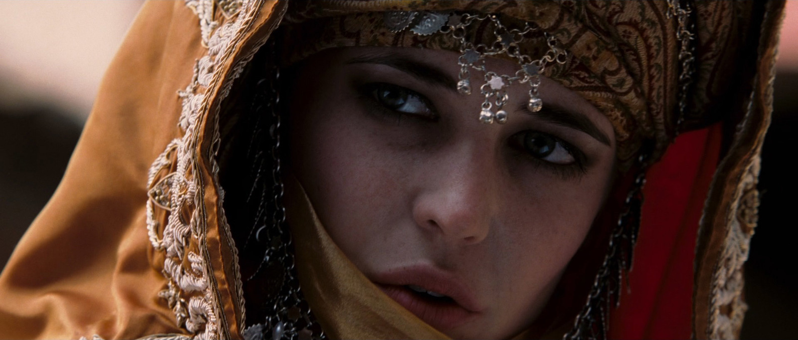 a close up of a person wearing a headdress