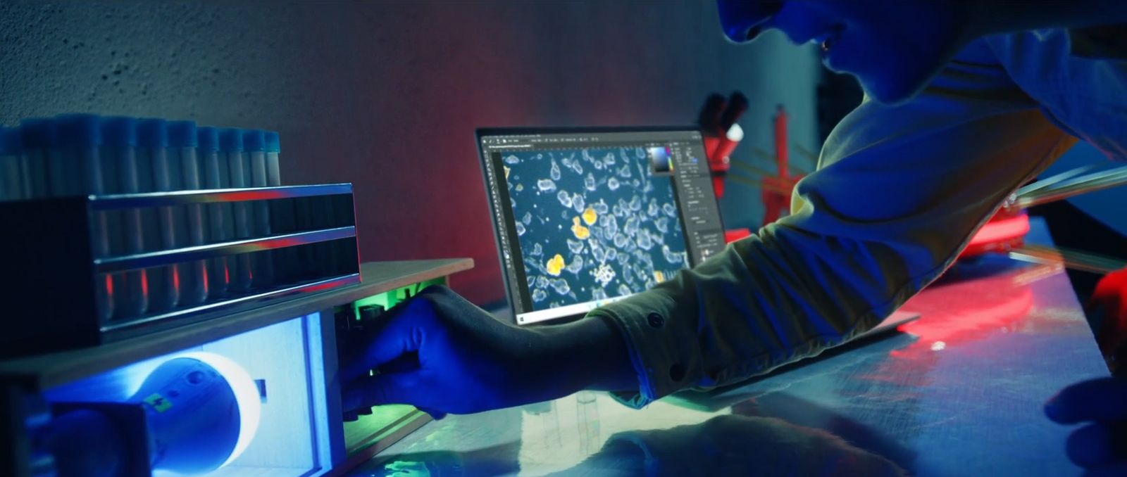 a man in blue gloves working on a computer