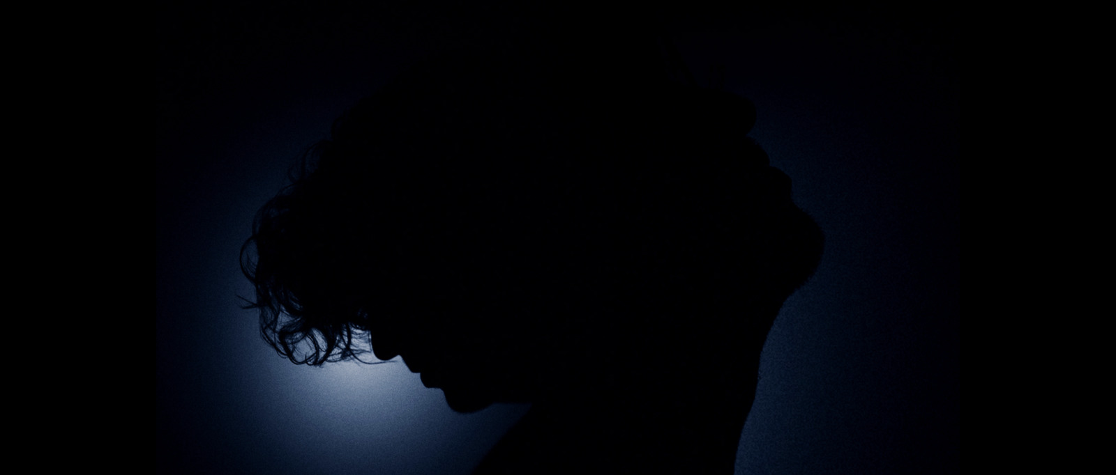 a silhouette of a person in the dark