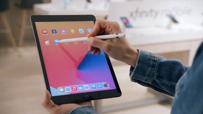 a person holding a tablet with a pen in their hand