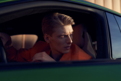 a man sitting in a car looking out the window