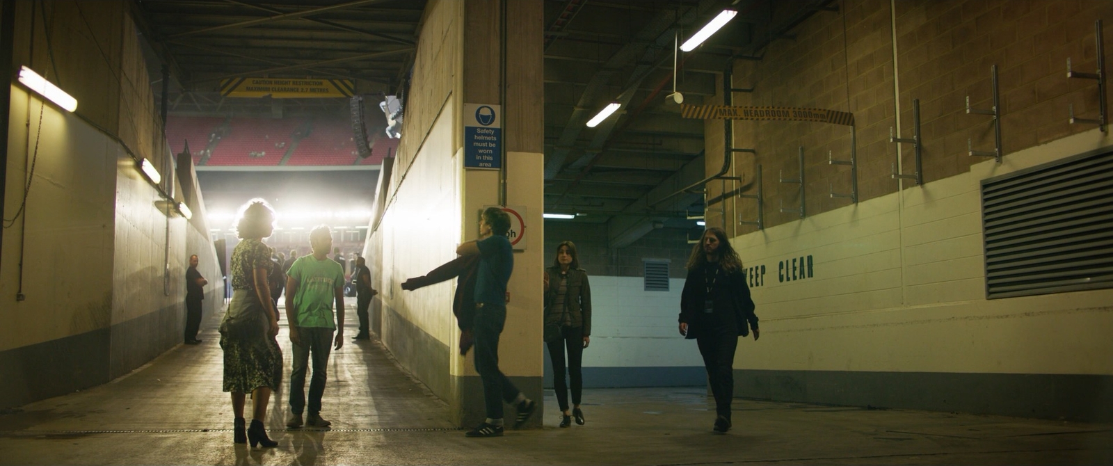 a group of people walking down a hallway