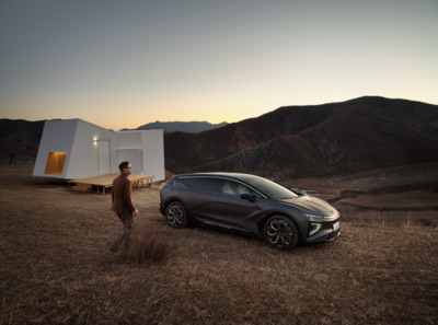 a man standing next to a car in a field