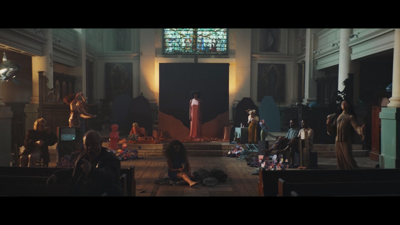 a group of people in a church with a stained glass window