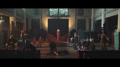 a group of people in a church with a stained glass window