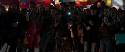 a group of people taking pictures with their cell phones