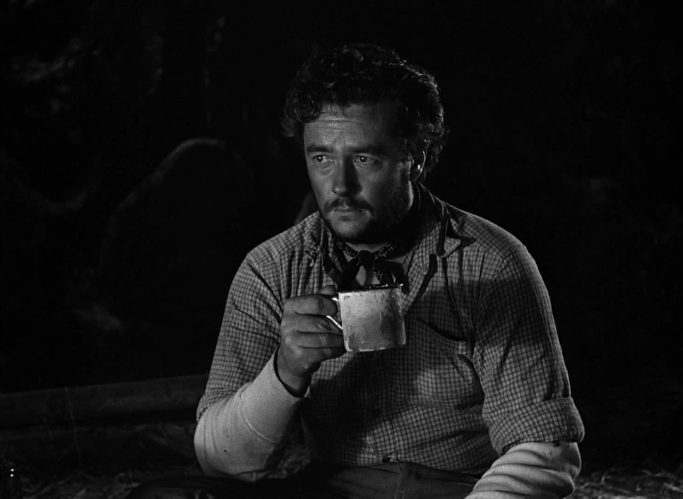 a man sitting down holding a cup of coffee