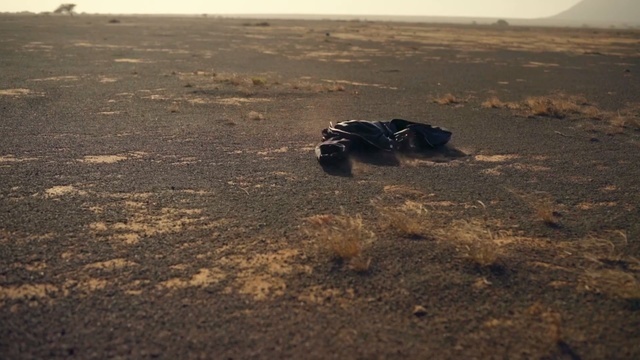 a pair of shoes sitting in the middle of a desert