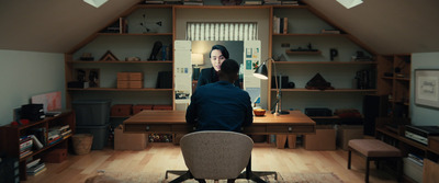 a person sitting at a desk in a room