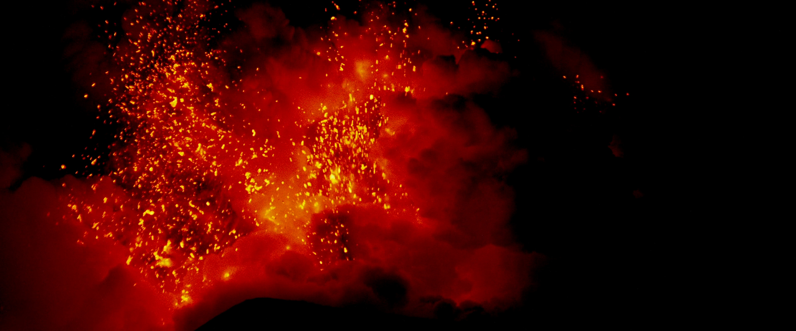 a red and black photo of a volcano