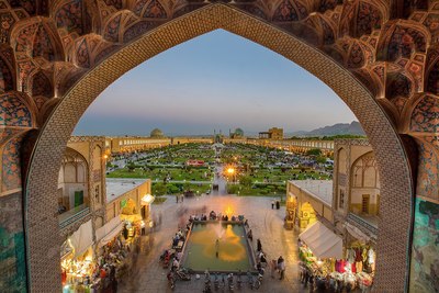 a view of a courtyard with a fountain in the middle of it