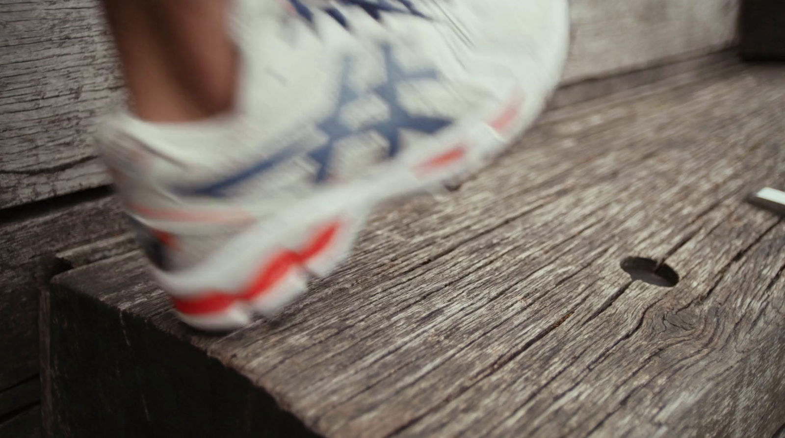 a close up of a person's shoe on a bench