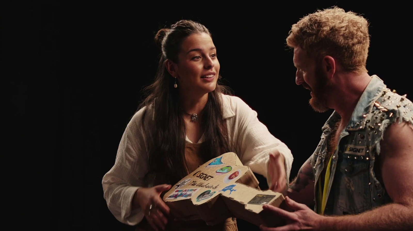 a man and a woman holding a cardboard box