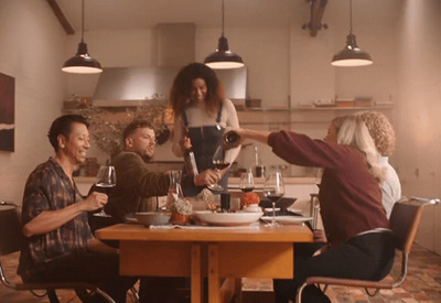 a group of people sitting around a wooden table